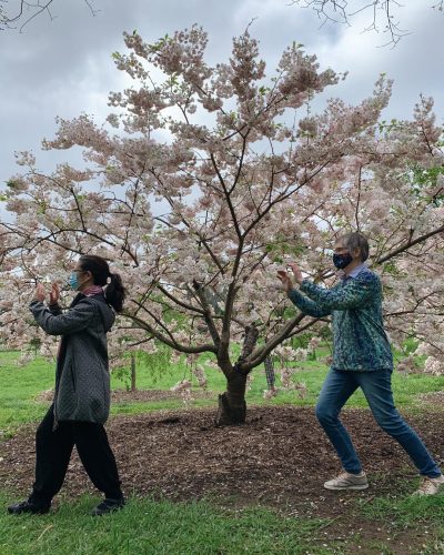 Two people in front of a tree